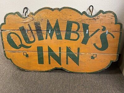 (eBay) Antique Quimby’s Inn 1x Thick Wooden Hanging Sign. This is an original advertising sign for an old Inn In mustard and forest green with 2 heavy iron hooks at the top for hanging. This sign is probably almost 100 years old so it needs some restoration, it’s intact but someone put metal clips on the between the op and middle board for stability. I’m sure you can remove and reglue for strength. It measures 36”across and 20.75” tall. No returns so ask all questions before bidding. Camp Signage, Antique Trade Sign, Western Signs, Wooden Signage, Sign Photography, Exterior Signage, Trade Sign, Antique Signs, Pub Signs