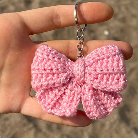 Cute Crochet Pink Coquette Bow Keychain Each toy is handmade by me and made to order. ✅SHIPPING Fast shipping - It will take 1-5 business days to print and ship 🚀 💚Each product is packed and shipped to you with lot of love and care 🧶Acrylic ✅SIZE Approx 5 cm width. ✅CARE INSTRUCTIONS - Wash by hand only. Soak in warm, soapy water without scrubbing. Allow to air dry. Avoid machine washing. - Do not bleach or iron. ✨Thank you so much for visiting my shop! If you have any questions, please feel Cute Crochet Things To Sell, Crochet Bag Decoration, Diy Gifts Crochet, How To Crochet A Keychain, Tiny Things To Crochet, Crochet Keychain Cute, Crochet Bag Keychain, Crochet Bow Keychain, Handmade Crafts Ideas Creative