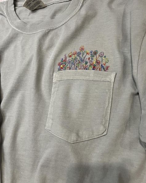 I love anything floral! This Comfort Colors pocket tee is so soft and the embroidered colorful flowers coming out of the pocket are so delicate and pretty. Other shirt colors and thread colors are also available. Please visit my Etsy shop for more. https://villageembroideryllc.etsy.com T Shirt Embroidery, Embroidery Tshirt, Thread Colors, Shirt Embroidery, Pocket Tee, Pocket Design, Colorful Flowers, Comfort Colors, Colorful Shirts