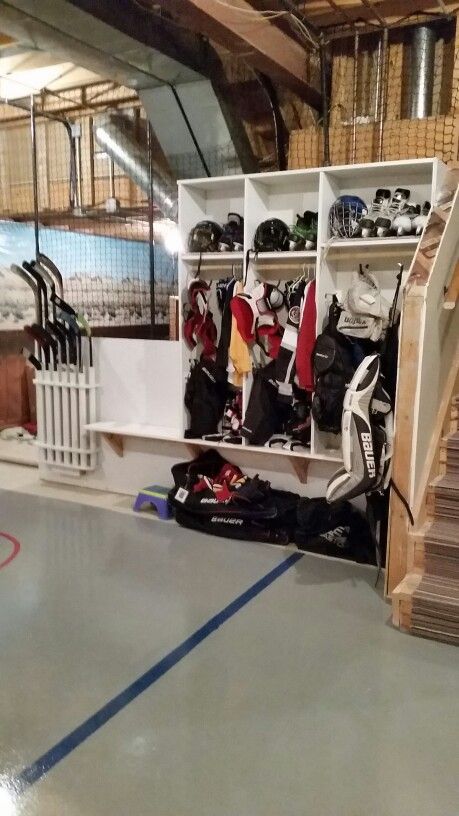 Garage Hockey Stick Storage, Hockey Gear Storage Cubbies, Hockey Storage Garage, Hockey Garage Storage, Hockey Locker Diy, Hockey Lockers In Garage, Hockey Bag Storage Ideas, Hockey Storage Ideas, Hockey Equipment Storage Ideas