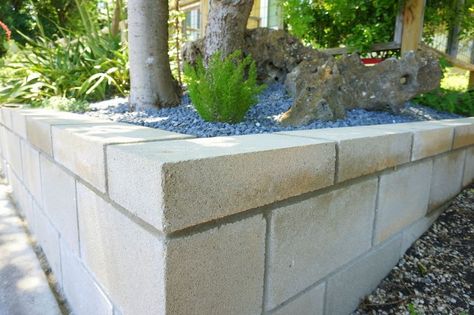 Retaining wall on a slope Cinder Block Retaining Wall, Cinder Block Garden Wall, Concrete Block Retaining Wall, Block Retaining Wall, Cinder Blocks Diy, Retaining Wall Patio, Diy Retaining Wall, Retaining Wall Design, Building A Retaining Wall