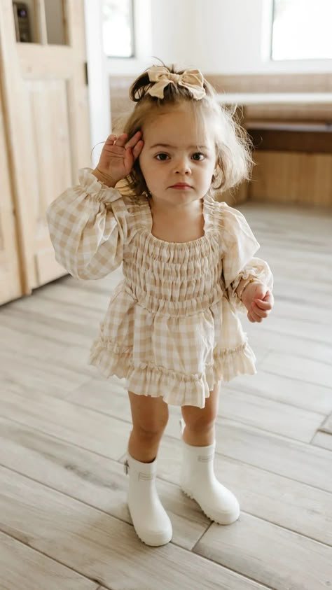 The sweetest ruffle romper with the perfect gingham pattern. Be sure to check out our matching dresses in child and adult sizes so everyone can match! Sizes Available : Newborn - 24 MonthsTo ensure your new ff product lasts as long as possible, consider these care tips : Washing Machine Settings : Use a gentle cycle with cold water to minimize wear and tear. Avoid overloading the machine to prevent excessive frictionDetergent Choices : Opt for mild detergents without harsh chemicals or bleach, which can degrade fabrics over timeDrying Techniques : Air-drying is preferable. If you must use a dryer, select a low-heat setting to reduce stress on the materialFabric Softeners : Fabric softeners can leave residues that weaken fibers and diminish performance so, we recommend avoid the use of them Baby Ruffle Romper, Gingham Romper, Baby Bow Hats, Baby Mode, Baby Girl Style, Kid Outfits, Baby Fits