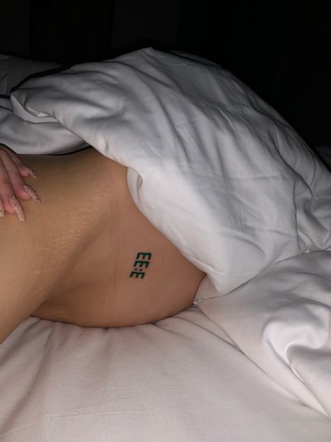 picture of small 333 tattoo on woman 777 Back Tattoo, Angle Number Tattoo Placements, Angel Number Tramp Stamp, Number Tattoos For Women, Angel Number 333 Tattoo, Small Tattoos Angel, 333 Angel Number Tattoo Ideas, 333 Tattoos, Small Number Tattoo