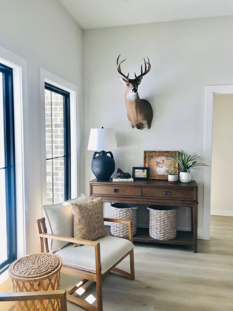 Antlers In Living Room, Antlers Interior Design, Deer Head Office Decor, Modern Farmhouse Living Room With Deer Mounts, Country Living Room With Deer Heads, Interior Design With Deer Heads, Fireplace Mantle Decor With Deer Head, Deer Head Dining Room, Gallery Wall Ideas With Deer Head