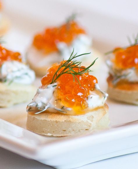 Blini canapes topped with sour cream, dill and caviar! Nothing is more Russian than these caviar blini served with cold vodka or drinks. Blini are essentially tiny pancakes that can be topped with pretty much anything, sweet or savory! I love the flavor combination for these blini and their size makes it easy to eat […] Russian Appetizers, Canapes Ideas, Russian Caviar, Caviar Appetizers, Delicious Healthy Food, Salmon Caviar, Canapes Recipes, Red Caviar, Ukrainian Recipes