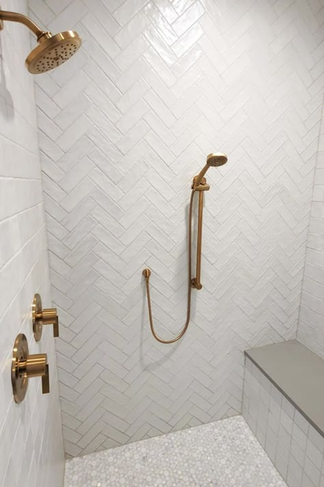 Do you need help choosing bathroom tiles for your bedroom? Let us help you create a modern space that’s easy to clean and maintain. Visit us at 📍Design Center Orem, Utah for a design consultation. 🏷 #Owsi #OwsiUSA #utahhome #tiledesign #tiles #moderntile  #bathroom #bath #bathroomtile #bathroomofinsta #bathroominspo #dreambathroom #housegoals #homerenovations #designinspirations #hexagontiles #graytiles #herringbonepattern #squaretiles #marbletiles #whitetiles #goldfixture Shower Tile Gold Fixtures, White Herringbone Shower, White And Gold Bathroom Ideas, Tiles For Bathroom Walls, Orem Utah, Tiles For Bathroom, Gold Fixtures, Modern Tiles, Shower Surround