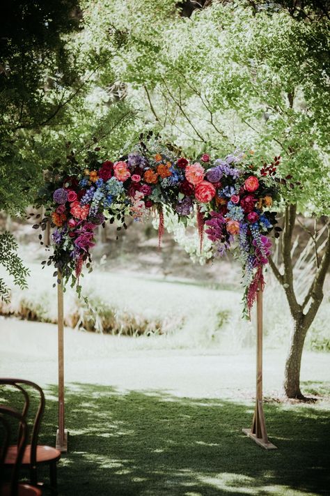 Floral arch | Image by Black Bird Tale Jewel Tone And Pastel Wedding, Colorful Ballroom Wedding, Colorful Wedding Arch, Floral Swag Wedding, Wedding Arbor Ideas, Jewel Tones Wedding, Chandelier Inspiration, Diy Arch, Jewel Toned Wedding