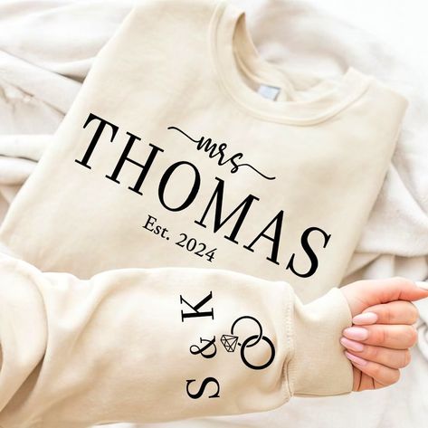 Wrap her in love with our Personalized Mrs Sweatshirt, the perfect Custom Wedding Gift or Anniversary Gift for Her. Whether she's the Bride To Be or celebrating years of wedded bliss, this Mrs Est Sweatshirt is a timeless keepsake. 👀 Ever wondered how to make a bride's day even brighter? 💖 Wrap her in warmth and affection with our Personalized Mrs Sweatshirt! Whether she's stepping into marital bliss or relishing years of cherished moments, this Custom Wedding Gift or Anniversary gem is the pe Mrs Shirts, Mrs Sweatshirt, Bride Sweatshirt, Mrs Shirt, Bride Shirts, Custom Wedding Gifts, New Journey, Anniversary Gift For Her, Bride To Be