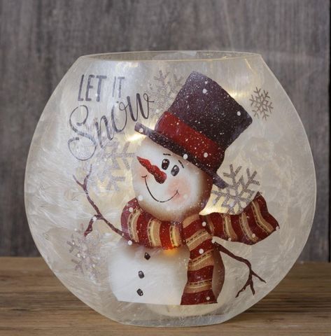 Bring a touch of winter magic to any room with our Frosted Glass Luminary! With a cute snowman design and a 6 hour timer, this versatile piece is perfect for the holiday season and beyond. Made of durable glass and measuring 7.5" x 7.5", it's sure to add charm to any space. Batteries not included. SPECIFICATION 6 Hr Timer | Requires 2 AA Batteries Made of: Glass Dimensions: 7.5" x 7.5" SHIPPING & RETURNS ships in 3 to 15 business days Shipping Policy Return Policy Pick-Up Policy Snowman Globe, Glass Snowman, Christmas Wine Bottles, Diy Glass Bottle Crafts, Painted Wine Bottles, Snowman Painting, Painting Glassware, Painted Jars, Glass Bottle Crafts