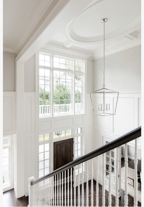 Foyer Molding, 2 Story Foyer Lighting, Dark Stained Wood Floors, White Marble Tile Floor, Foyer Ideas Entryway, Wainscoting Ideas, Steel Frame Doors, Foyer Staircase, Wainscoting Styles