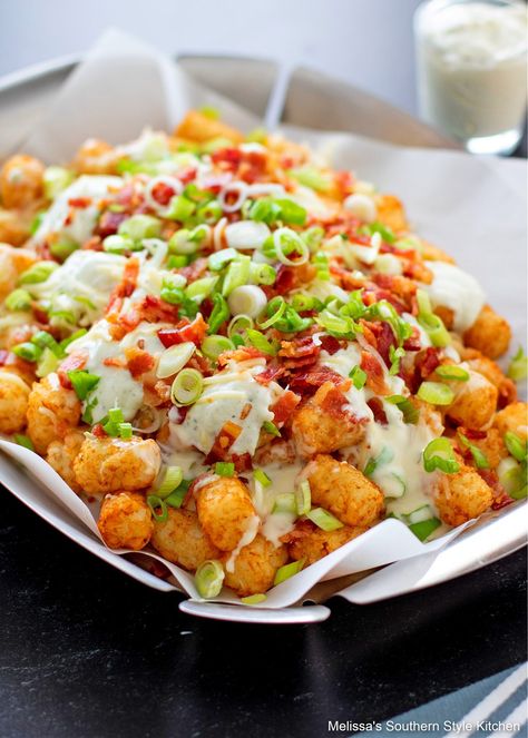 This fun to make Loaded Tater Tots Recipe can be served as an appetizer, side dish or for game day snacking #tatertots #loladedtatertots #queso #cheesytatertots #taterttotsrecipe #potatoes #potatorecipe #easyrecipes #sidedishrecipes #appetizers #southernrecipes Tater Tot Nachos, Loaded Tater Tots, Seasoned Sour Cream, Burger Side Dishes, Tater Tot Recipes, Game Day Snacks, Tater Tots, Easy Appetizer Recipes, Beef Dinner