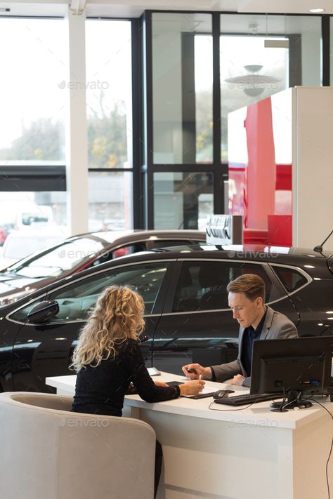 Female customer discussing with salesman in carshowroom by Wavebreakmedia. Female customer discussing with salesman while sitting at desk in carshowroom #Sponsored #discussing, #salesman, #Female, #customer Female Car Salesman Outfit, Car Dealership Aesthetic, Sitting At Desk, Auto Garage, Business Portrait Photography, Car Salesman, Company Job, Employer Branding, Car Sales