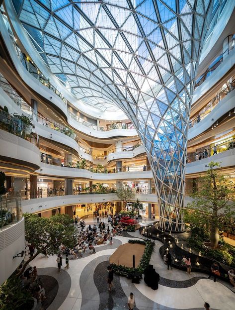 An expansive atrium serves as the heart of this shopping complex. Using unique shapes and materials it brings in natural light and creates a spacious feel for all visitors.  📍Xi'An, China Shopping Center Architecture, Shopping Mall Design, Mall Facade, Atrium Design, Shopping Mall Architecture, Retail Architecture, Monumental Architecture, Commercial Complex, Mall Design