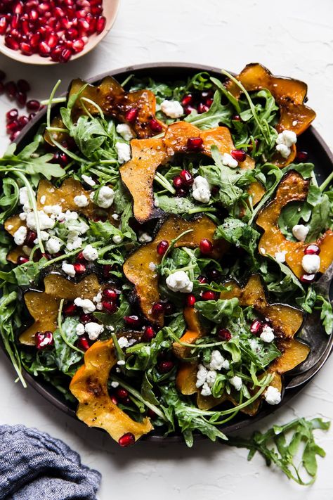 Peppery arugula and a zingy, creamy goat cheese dressing elevate this bright, colorful roasted acorn squash salad to heights worthy of your holiday table. Salads Winter, Roasted Squash Salad, Salads To Make, Roasted Veggie Salad, Winter Salads, Winter Salad Recipes, Thanksgiving Salad, Acorn Squash Recipes, Squash Salad