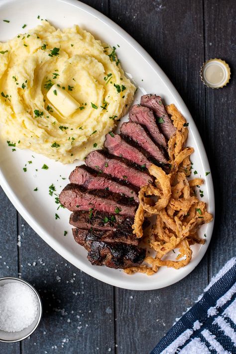 Garlic Butter Steak with Fried Onion Strings and Mashed Potatoes Recipe Steak And Mash Potatoes, Fried Onion Strings, Steak With Mashed Potatoes, Steak And Mashed Potatoes, Onion Strings, Steak And Broccoli, Strip Steak Recipe, Steak And Potatoes, Fried Steak Recipes