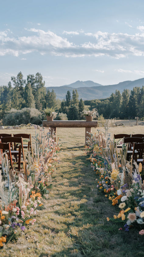 A wedding aisle beautifully lined with diverse, colorful wildflowers, leading to an outdoor ceremony. Wedding Aesthetic Garden, May Wildflower Wedding, Indoor Aisle Decor, Summer Wedding Colors Wildflowers, Backyard Wedding Wildflowers, Sunset Color Flower Arrangements, Wildflower Wedding Aisle Decorations, Wedding Aesthetic Spring, Wildflower Inspired Wedding