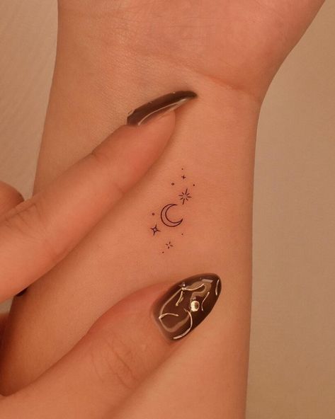 26 Sparkle Tattoo Designs To Find Your Stellar Inspiration Moon With Sparkles Tattoo, Celestial Finger Tattoos For Women, Tiny Moon Tattoos For Women, Simple Moon Tattoo Designs, Tattoo Moon And Stars, 00 00 Tattoo, Unique Moon Tattoo Ideas, Shiny Tattoo, Stars And Moon Tattoo