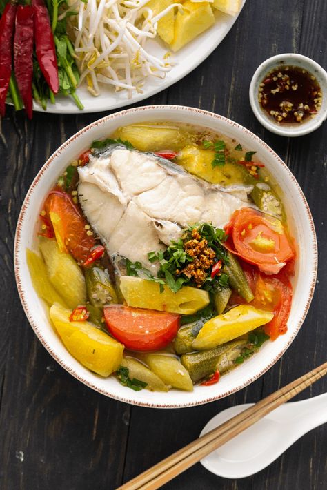 Canh Chua is an iconic Vietnamese Sour Soup, loved for its broth that's sweetened by pineapple and garnished with fresh herbs! #vietnamesesoursoup #vietnamesesoup #canhchua Vietnamese Sour Soup, Vietnamese Fish Soup, Canh Chua Recipe, Catfish Soup, Sour Fish Soup, Sweet And Sour Fish, Canh Chua, Vietnamese Soup, Khmer Food