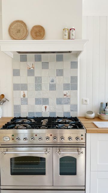 Yvonne Eijkenduijn on Instagram: "We made a tiled backsplash behind the stove in the kitchen using @storytiles We used a London City tile (my favourite city) Den Bosch (Bo’s hometown) Bookworm (quite obviously) flowers and a sailboat. We mixed them with original Dutch “witjes” and an azur blue tile." Kitchen Tiles Backsplash Behind Stove, Tile Only Behind Stove, Blue Kitchen White Backsplash, Kitchen Wall Tiles Behind Oven, Tile Backsplash Behind Stove Only, Blue And White Tile Kitchen, Tile Backsplash Kitchen Behind Stove, Bathroom Upcycle, Backsplash Behind Stove Only