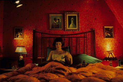 Shot in saturated colour, Amelie was as rich in home inspiration as it was in verse. The title character's bedroom was every bit as quirky as she was with its thick quilted bedspread, dark red wallpaper, boudoir lampshades and be-coned dog portraits. | Best On Screen TV Film Interior Inspiration | British Vogue Amelie Apartment, Movie Bedroom, Michael Sowa, Color In Film, George Miller, Damien Chazelle, Xavier Dolan, Mulholland Drive, Dark Red Wallpaper