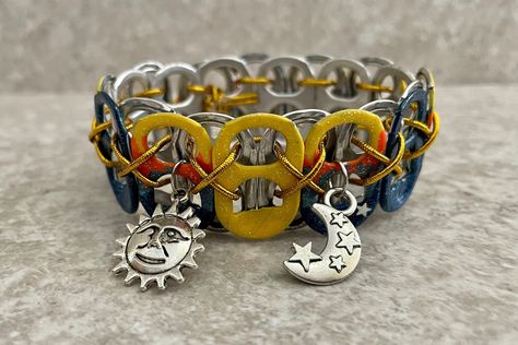 Enjoy this celestial sun and moon themed bracelet, handmade from recycled tabs off soda pop cans. The sun and moon charms are accented by blue and yellow pop tabs, and just a little bit of glitter.  Bracelets are strung with elastic cord for comfort, and can fold flat for storage or travel. Please choose your size at checkout: XS - 10 tabs, approx. 6 inches (child-size wrist) S - 11 tabs, approx 7 inches (small-boned wrist) M - 12 tabs, approx. 8 inches (medium-boned wrist) L - 13 tabs, approx. Tabs Soda, Soda Tab Bracelet, Pop Tab Bracelet, Tab Bracelet, Soda Tab Crafts, Soda Can Tabs, Pop Tab Crafts, Can Tabs, Soda Tabs