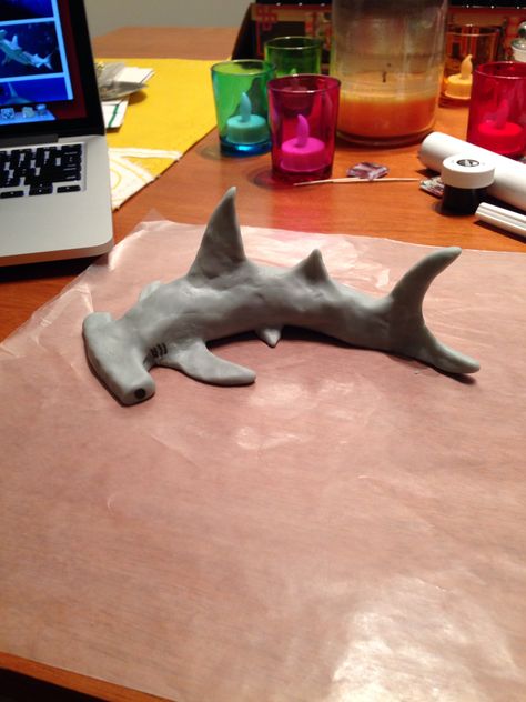 Hammerhead Shark made with Wilton edible modeling dough #sharkcake Modeling Clay Sculpture Ideas, Hammerhead Shark Paper Mache, Sea Animal Sculpture, Hammerhead Shark Sculpture, Shark Out Of Clay, Sea Animal Clay Sculpture, Shark Ceramic Sculpture, Cardboard Hammerhead Shark, Clay Shark Tutorial