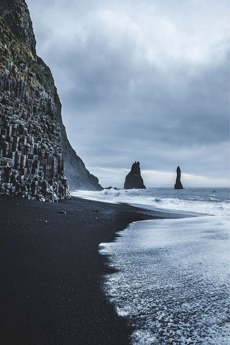 Reynisfjara, a beach of black sand and pebbles smoothed by the sea unique in the world, two majestic stacks emerge from the fog and then flow into the sea Iceland Honeymoon, Iceland Winter, Vacation Locations, Travel Finds, Peru Travel, Black Sand Beach, The Fog, Iceland Travel, Black Sand