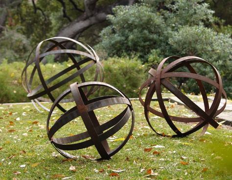 Rusted Iron Spheres  The Rusted Iron Spheres are available in three sizes: 18, 24, and 36-inches in diameter, starting at $145 at Potted. Corten Steel Garden, Garden Spheres, Unique Garden Art, Barrel Rings, Decorative Spheres, Metal Garden Art, Unique Gardens, Diy Metal, Garden Crafts