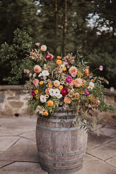 Bright pastels and wildflowers come together in perfect harmony at the Inn at Grace Winery wedding. The wedding features breathtaking floral designs that encapsulate the essence of a romantic vineyard wedding. Get inspired for your big day with florals that are as vibrant and joyful as your love story! Wedding Flowers On Barrels, Wedding Ideas Winery, Simple Wedding Flower Decorations, Romantic Flowers Wedding, Country Wildflower Wedding, British Countryside Wedding, Texas Wildflower Wedding, Wildflower Floral Arrangements, Western Wildflower Wedding