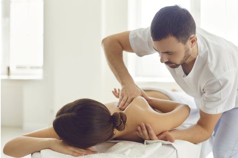 Professional masseur or manual therapist massaging young woman's shoulder, easing pain and relaxing muscles. Female patient getting remedial body massage in health clinic or physiotherapy center Mobile Navigation, Medical Photos, Wellness Massage, Medical Uniforms, Deep Tissue Massage, Experience Gifts, Deep Tissue, Massage Therapist, Private Room