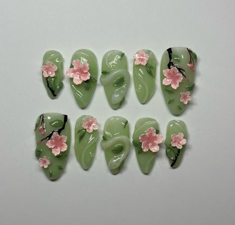 I really wish to see the cherry blossom trees in Japan or Korea one day 🌸 Available now on my etsy! Link in bio Using @makartt_official @beetlesgelpolish #pressonnails #cherryblossom #pinknails #greennails #flowernails #gelnails Mitsuri Inspired Nails, Sculpted Flower Nails, Nails Green And Pink, Princess And The Frog Nails, Pink And Green Nail Art, Press On Nails Packaging Ideas, Green Nails Art, Pink Green Nails, Green And Pink Nails