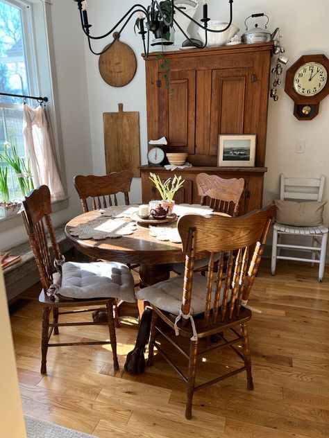 Antique stepback cupboards, woods and whites antique decor, farmhouse style, vintage decor, new old house inspo, revere pewter trim color, oak floors, snowbound by sherwin williams wall color, kitchen inspo, vintage cutting boards, cottage farmhouse Antique Farmhouse Furniture, Cozy Dining Room Decor, Vintage Cottage Dining Room, Other Ways To Use Dining Room Space, Cottage Dining Table Decor, Dining Room Table Vintage, Old Farmhouse Dining Room, Vintage Dining Table Decor, Table In Middle Of Kitchen