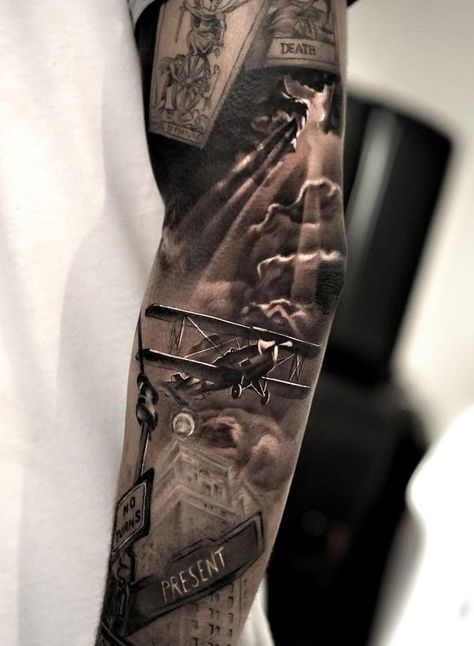 A true picture of the war beautifully woven into one big tattoo. There are black clouds as a symbol of the evil time and fate of a country in a given period of time. Tattoo Daruma, Tattoo Costillas, Aviation Tattoo, Herren Hand Tattoos, Progress Tattoo, Tattoo Son, Airplane Tattoos, Army Tattoos, Military Tattoos