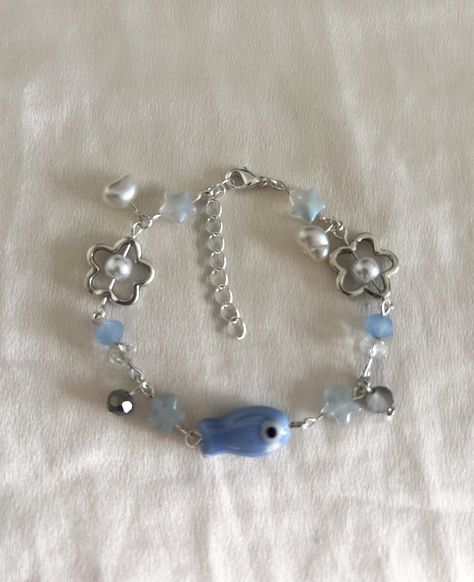 Dive into the depths of beauty with our Oceana Charm Bracelet! Inspired by the wonders of the ocean, this stunning accessory brings the tranquil vibes of the sea to your wardrobe. Featuring a central Japanese inspired fish charm, natural-shaped pearls, and beautiful blue accents, it's the perfect piece for ocean lovers. 🌊 Natural Ocean Theme: Embrace the serenity of the sea with this bracelet's natural, ocean-inspired design. From the delicate fish charm to the lustrous pearls and blue accents, Ocean Theme Bracelet, Fish Bracelet, Ocean Bracelet, Yarn Bracelets, Bracelet Inspired, Fishing Bracelet, Beads Craft Jewelry, Bottle Charms, Jewelry Accessories Ideas