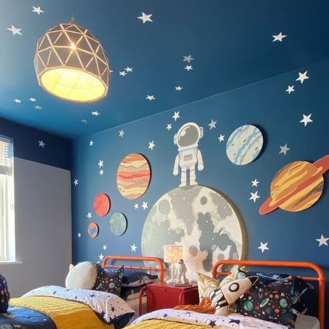 Artspace Interior Design LTD on Instagram: "Look at the space room in full effect 🤩🤩 the pops of bright colours in the furniture has helped to lift the darker colour on the walls and also kept it really fun! Design & Install: @artspaceinteriordesign . . . . . . . . #interiordesign #interiorstyling #interiors #kidsroom #spacetheme #twinroom #outthere #paintedceiling #newhome #showhome #planets #stars #spaceman" Dinosaur Space Bedroom, Toddler Space Bedroom, Boys Room Wall Ideas, Boys Room Space Theme, Space Toddler Room, Space Bedroom Boys, Toddler Space Room, Kids Space Room, Kids Space Bedroom