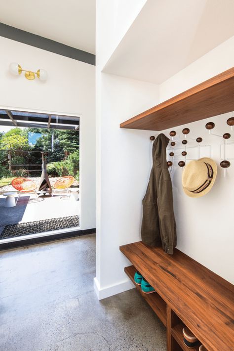 Serving as a transitional area to the back yard, the mud room’s custom shelving echoes the walnut touches found throughout the kitchen. Vct Flooring, Mid Century Entryway, Mid Century Renovation, Mid Century Modern Renovation, Mod Furniture, Mudroom Entryway, Blue Backsplash, Modern Renovation, Custom Shelving