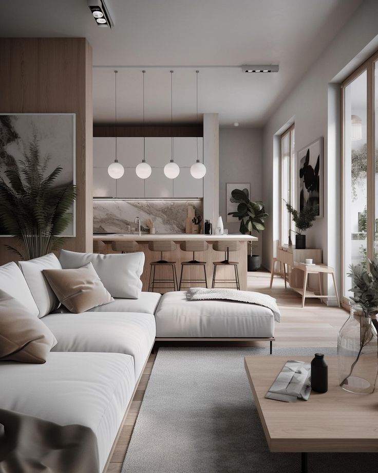 a living room filled with white furniture and lots of windows next to a wooden table