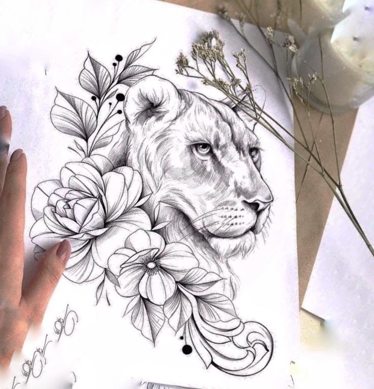 a drawing of a lion with flowers on it's face and hands next to paper