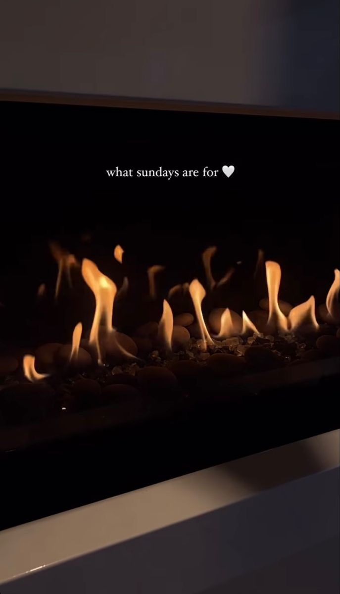 a close up of a fire in a stove with the words what sunday's are for?