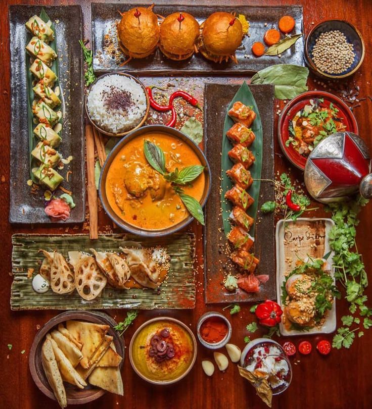 an overhead view of various food items on a wooden table with oranges and other foods