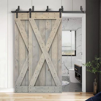 an open sliding door in a white room with wood flooring and black accents on the walls