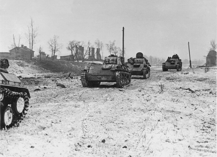 several tanks are lined up on the snow covered ground in this black and white photo