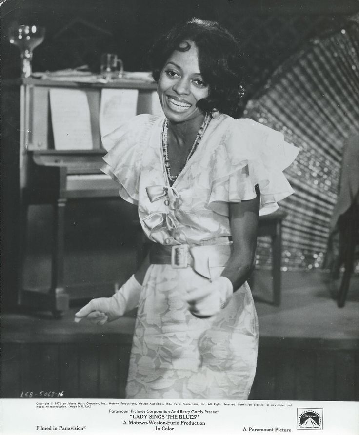 a black and white photo of a woman smiling