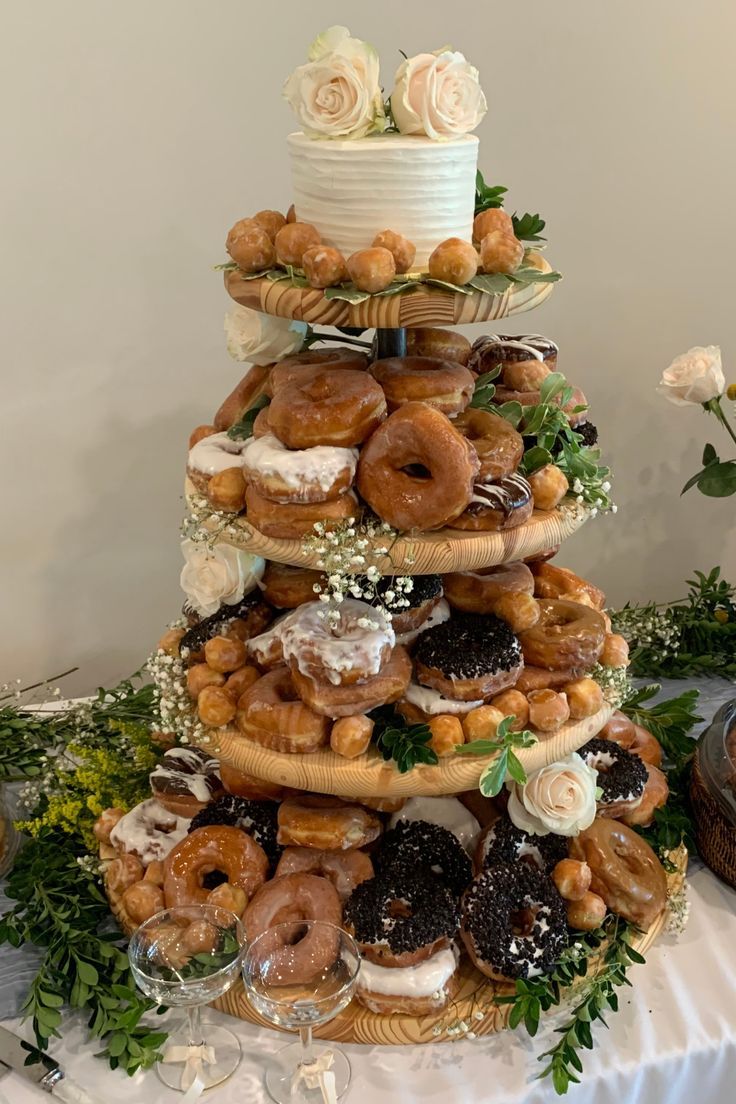 a large cake made out of doughnuts and other pastries on a table