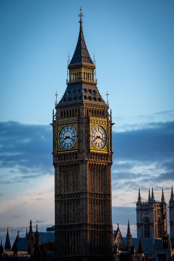 the big ben clock tower towering over the city of london, england at sunset or dawn