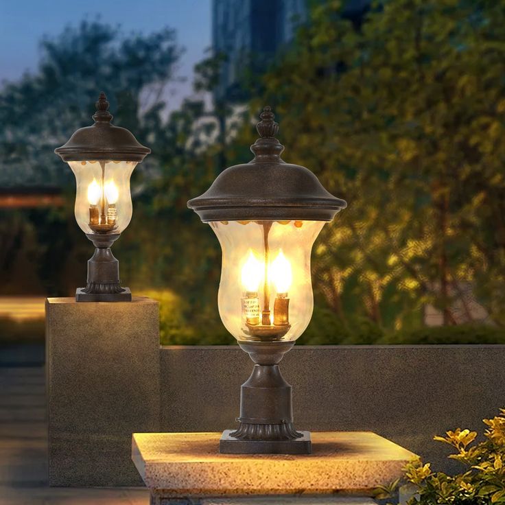 two lamps are sitting on top of cement blocks