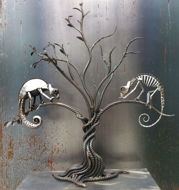 a metal tree with two different types of animals on it