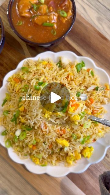 a plate full of rice and vegetables next to bowls of sauces on a wooden table