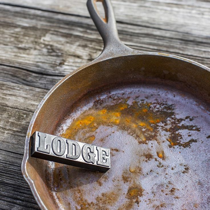 a frying pan filled with food and the word lodge written in metal on it