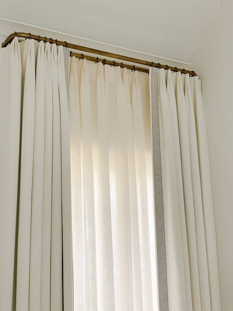 an open window with white drapes and curtains